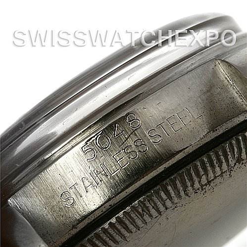 The image shows a close-up of the side of a Rolex Vintage Collection 5048 Men's Stainless Steel Silver Dial 5048 Men's Stainless Steel Silver Dial watch, highlighting the stainless steel casing with engravings.