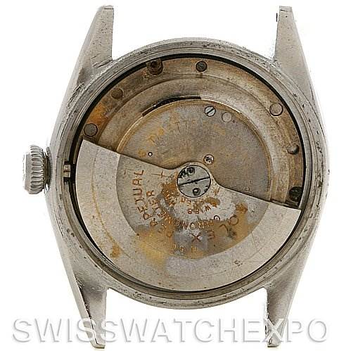 The image shows the back of a Vintage Collection Rolex watch with its movement and rotor visible.