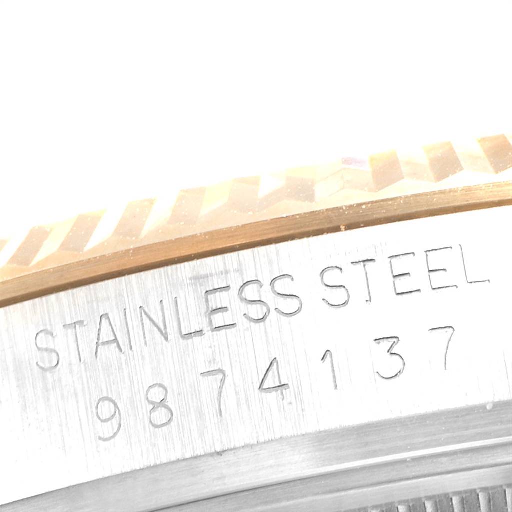 This image shows a close-up of the engraved serial number and part of the bezel on a Rolex Vintage Collection 16013 Men's Stainless Steel Champagne Dial 16013 Men's Stainless Steel Champagne Dial stainless steel watch.