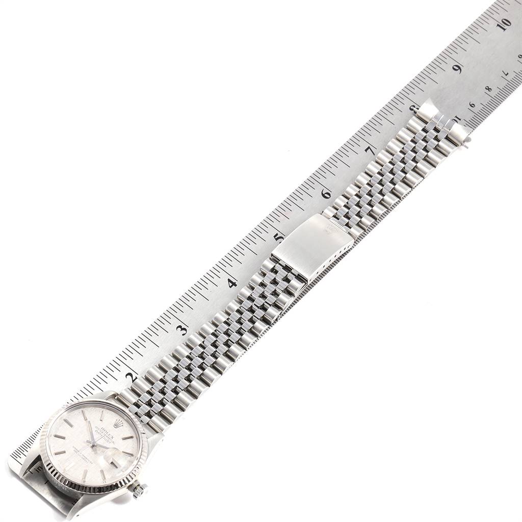 The image shows the face and metal bracelet of a Rolex Vintage Collection 16014 Men
s Stainless Steel Silver Dial 16014 Men
s Stainless Steel Silver Dial model watch measured against a ruler.