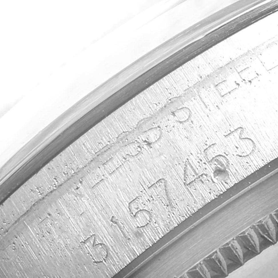 The image shows a close-up of the engraved serial number and part of the bezel of the Rolex Vintage Collection 1500 Men
s Stainless Steel Silver Dial 1500 Men
s Stainless Steel Silver Dial watch.