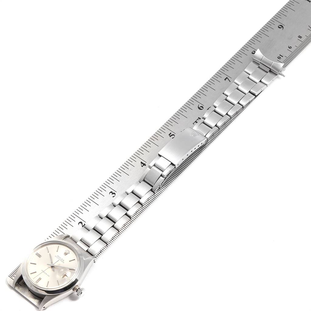 The image shows a Rolex Vintage Collection 6694 Men
s Stainless Steel Silver Dial 6694 Men
s Stainless Steel Silver Dial watch with its bracelet extended and measured against a ruler.