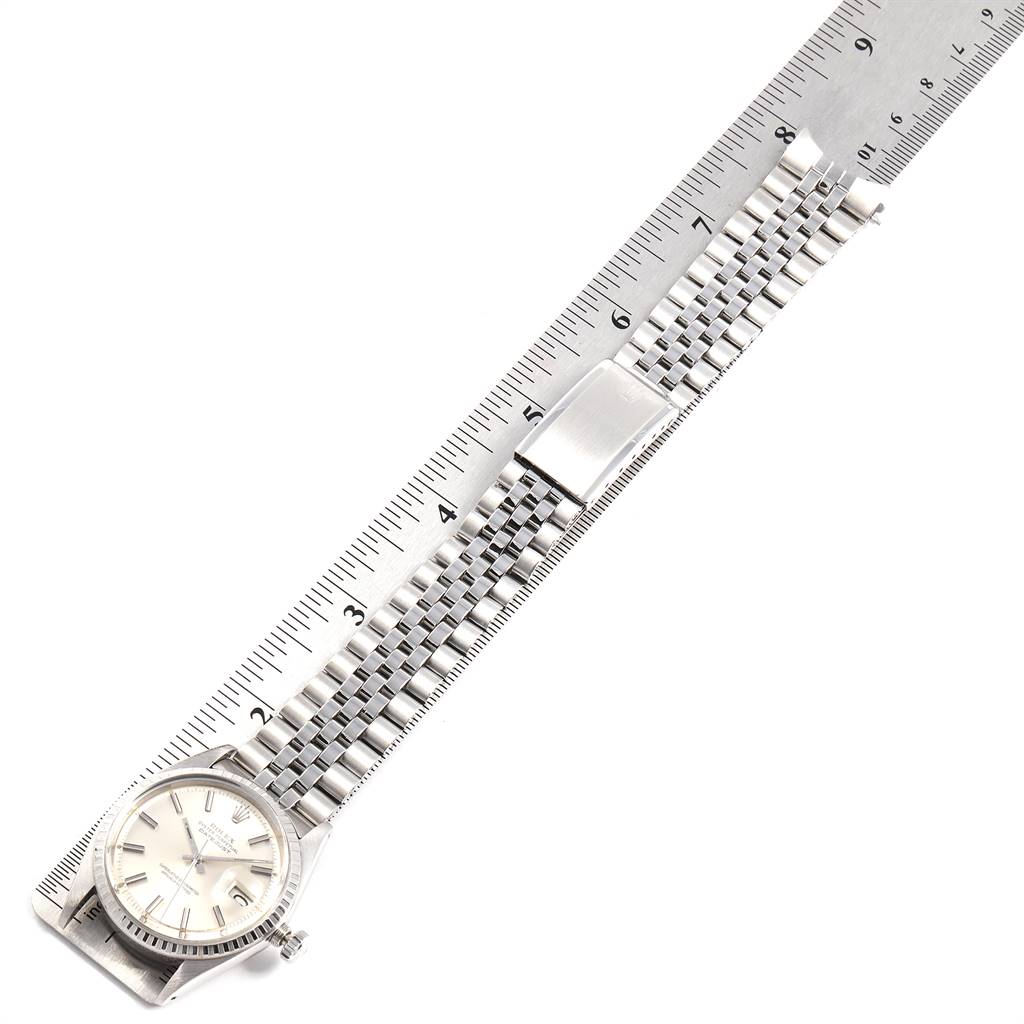 The Rolex Vintage Collection 1603 Men
s Stainless Steel Silver Dial 1603 Men
s Stainless Steel Silver Dial watch is shown from an overhead angle with the dial, bracelet, and clasp visible along a ruler.