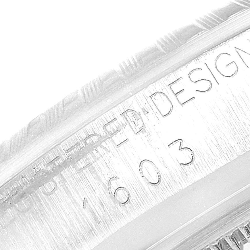 The image shows an engraved side of the Rolex Vintage Collection 1603 Men
s Stainless Steel Silver Dial 1603 Men
s Stainless Steel Silver Dial model 1603 watch case at a close-up angle.