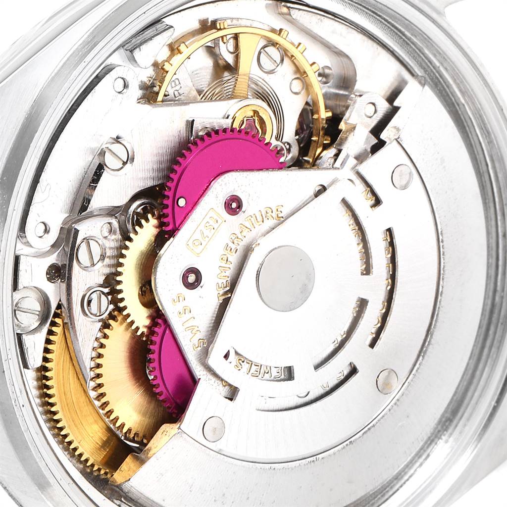This image shows the intricate internal mechanics of a Rolex Vintage Collection 1603 Men
s Stainless Steel Silver Dial 1603 Men
s Stainless Steel Silver Dial watch, specifically its movement and gears.