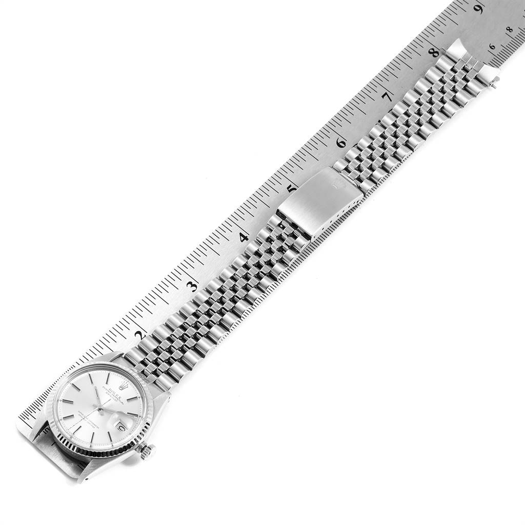 The Rolex Vintage Collection 1601 Men
s Stainless Steel Silver Dial 1601 Men
s Stainless Steel Silver Dial watch is shown in a top-down angle with a stainless steel band and ruler for scale.