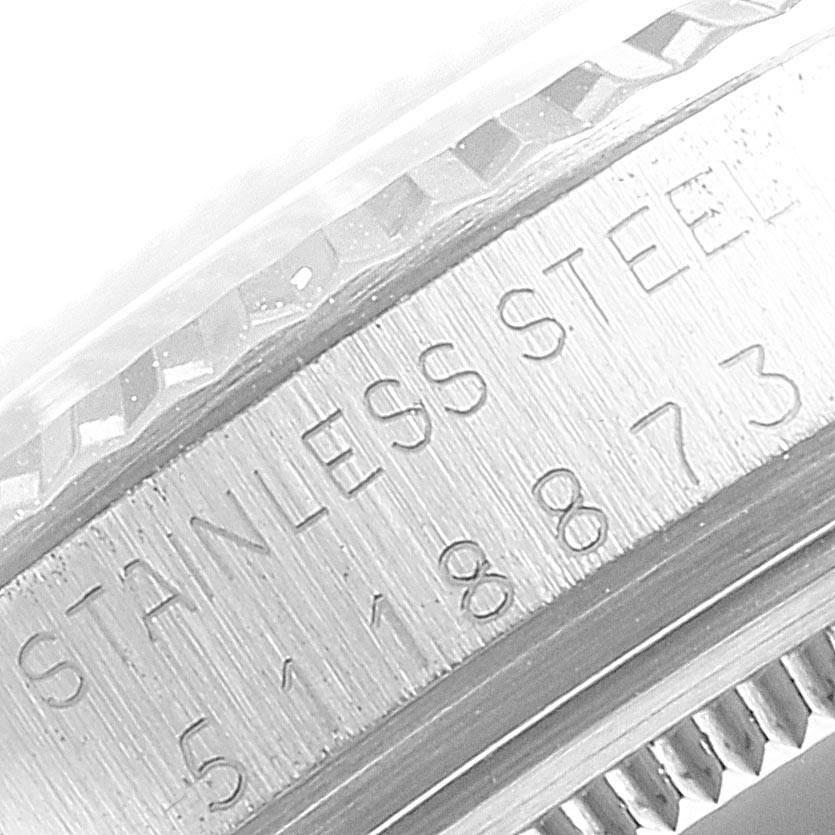 The image shows a close-up of the engraved serial number and "Stainless Steel" text on the side of a Rolex Vintage Collection 1601 Men
s Stainless Steel Silver Dial 1601 Men
s Stainless Steel Silver Dial watch.
