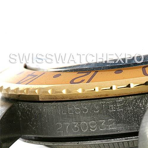 This image shows a close-up side view of the bezel and case of a Rolex Vintage Collection 1675 Men's Stainless Steel Brown Dial 1675 Men's Stainless Steel Brown Dial watch, displaying part of the serial number and "STAINLESS STEEL" engraving.
