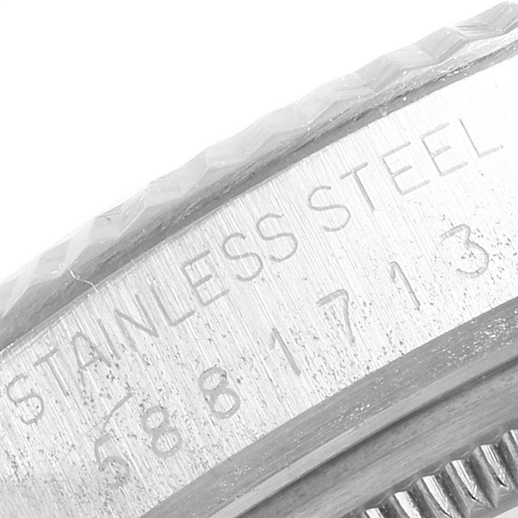 The image shows a close-up of the side engraving and bezel of a Rolex Vintage Collection 16014 Men
s Stainless Steel Silver Dial 16014 Men
s Stainless Steel Silver Dial watch, focusing on the stainless steel marking and serial number.