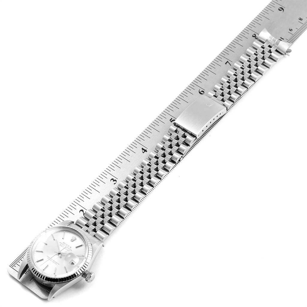 This image shows a Rolex Vintage Collection 16014 Men
s Stainless Steel Silver Dial 16014 Men
s Stainless Steel Silver Dial watch from an overhead angle, highlighting the silver bracelet and part of the watch face.