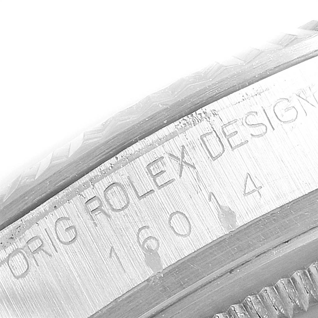 This image shows a close-up of the side of a Rolex Vintage Collection 16014 Men
s Stainless Steel Silver Dial 16014 Men
s Stainless Steel Silver Dial watch, highlighting the engraved model number and “ROLEX DESIGN.”