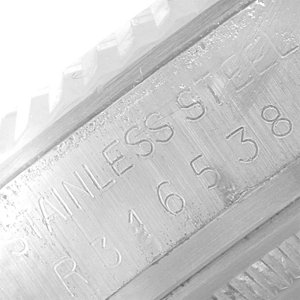 The image shows a close-up of the side of a Vintage Collection Rolex watch, highlighting the stainless steel and serial number engraving.