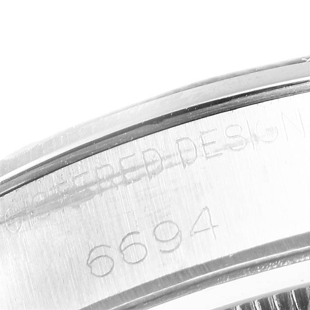 The image shows a close-up of the serial number and engravings on the casing of a Rolex Vintage Collection 6694 Men
s Stainless Steel Silver Dial 6694 Men
s Stainless Steel Silver Dial model 6694.