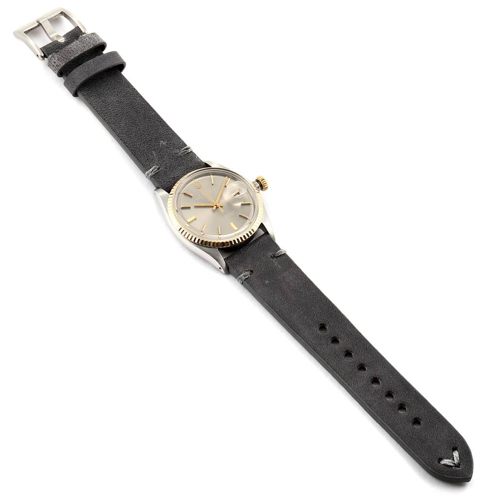 This is a top-view angle of a Rolex Vintage Collection 1601 Men's Steel and Gold (two tone) Grey Dial 1601 Men's Steel and Gold (two tone) Grey Dial model watch displaying its face, crown, and the entire strap.