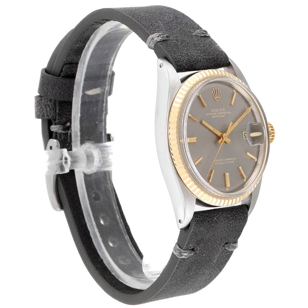 The image shows a side angle of the Rolex Vintage Collection 1601 Men's Steel and Gold (two tone) Grey Dial 1601 Men's Steel and Gold (two tone) Grey Dial model, highlighting the grey dial, gold bezel, and black leather strap.