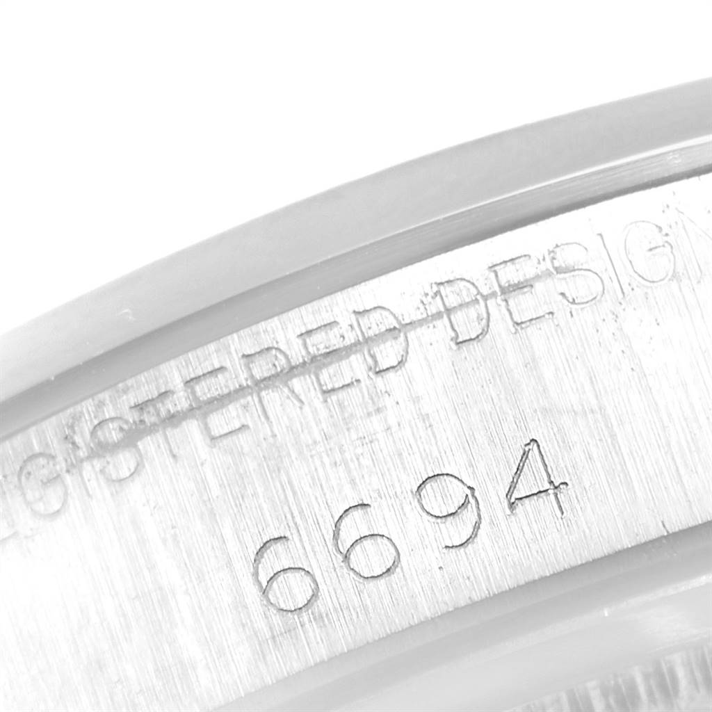 This close-up shows the engraved model number "6694" on the case side of a Rolex Vintage Collection 6694 Men's Stainless Steel Black Dial 6694 Men's Stainless Steel Black Dial watch.