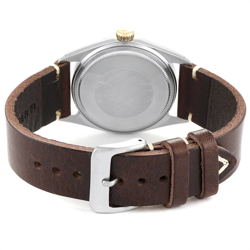 This image shows the back case, crown, and leather strap of the Rolex Vintage Collection 1601 Men
s Steel and Gold (two tone) Blue Dial 1601 Men
s Steel and Gold (two tone) Blue Dial watch from a rear angle.