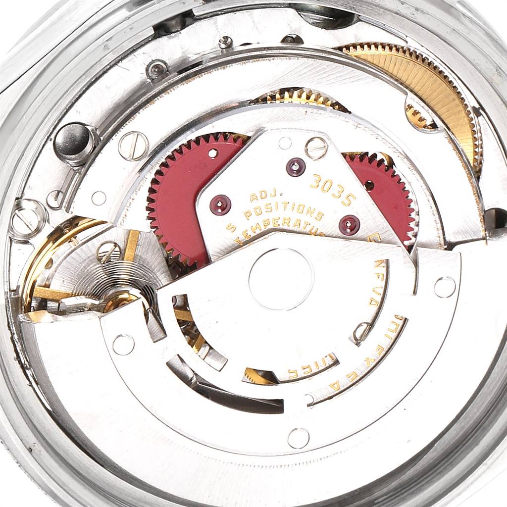 The image shows the detailed mechanism of a Rolex Vintage Collection 16030 Men's Stainless Steel Silver Dial 16030 Men's Stainless Steel Silver Dial model watch, focusing on its internal gears and adjustment markings.