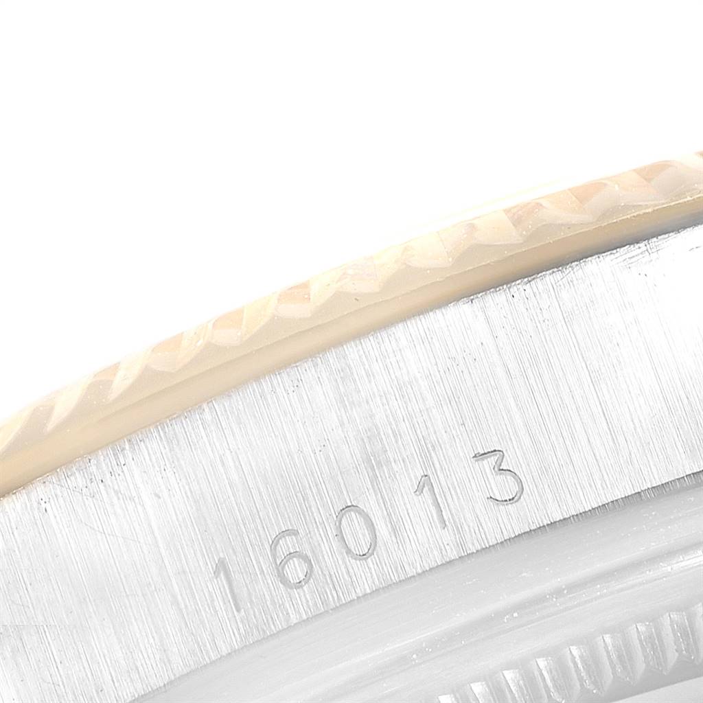 This close-up image shows the engraved serial number and the edge of the bezel of a Rolex Vintage Collection 16013 Men
s Stainless Steel Black Dial 16013 Men
s Stainless Steel Black Dial model 16013.