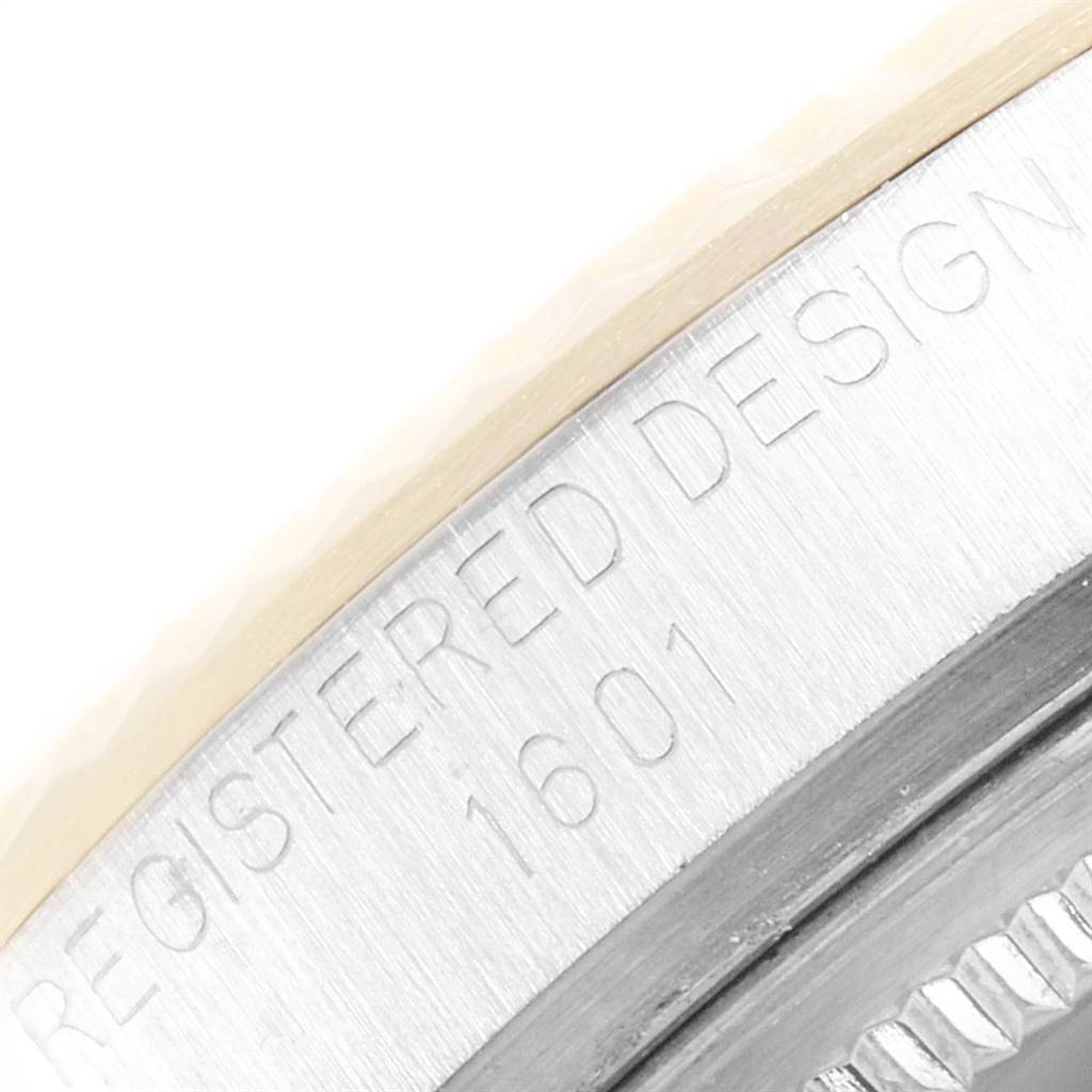This image shows a close-up of the case side of a Rolex Vintage Collection 1601 Men's Steel and Gold (two tone) White Dial 1601 Men's Steel and Gold (two tone) White Dial model, highlighting the "Registered Design 1601" engraving.
