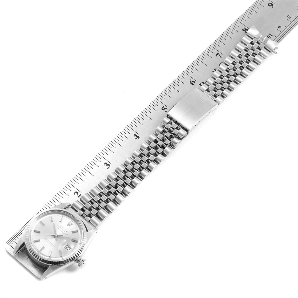 The image shows a Rolex Vintage Collection 1601 Men's Stainless Steel Silver Dial 1601 Men's Stainless Steel Silver Dial model watch lying flat with its bracelet fully extended next to a ruler.