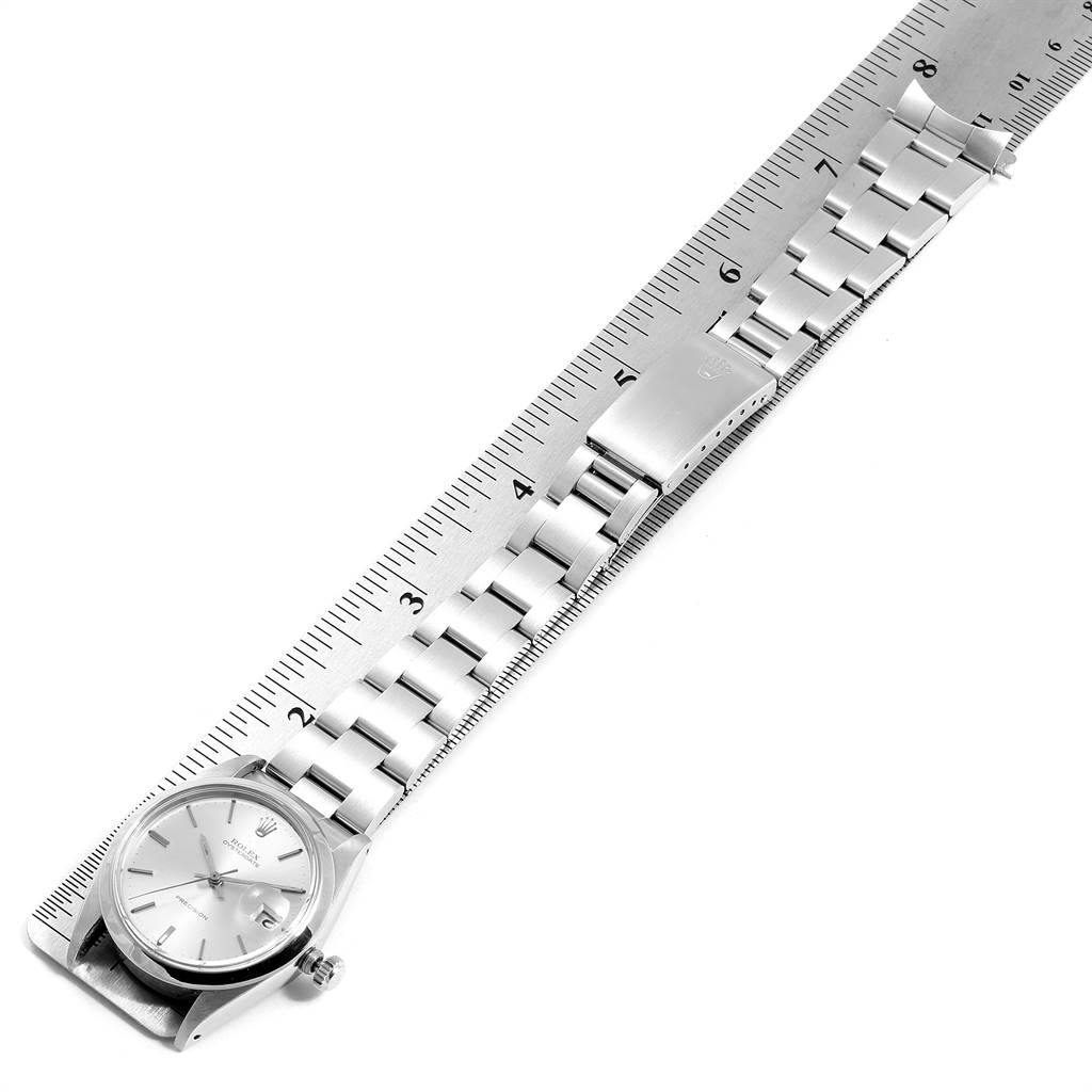 The Rolex Vintage Collection 6694 Men
s Stainless Steel Silver Dial 6694 Men
s Stainless Steel Silver Dial watch is shown at an angled top view, highlighting the watch face, bracelet, and clasp alongside a ruler.