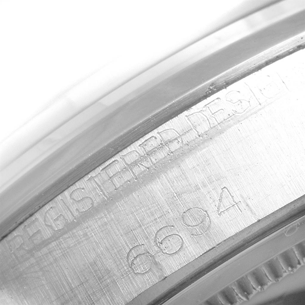 This close-up image of the Rolex Vintage Collection 6694 Men
s Stainless Steel Silver Dial 6694 Men
s Stainless Steel Silver Dial model shows the engraved serial number and text on the watch
s case edge.