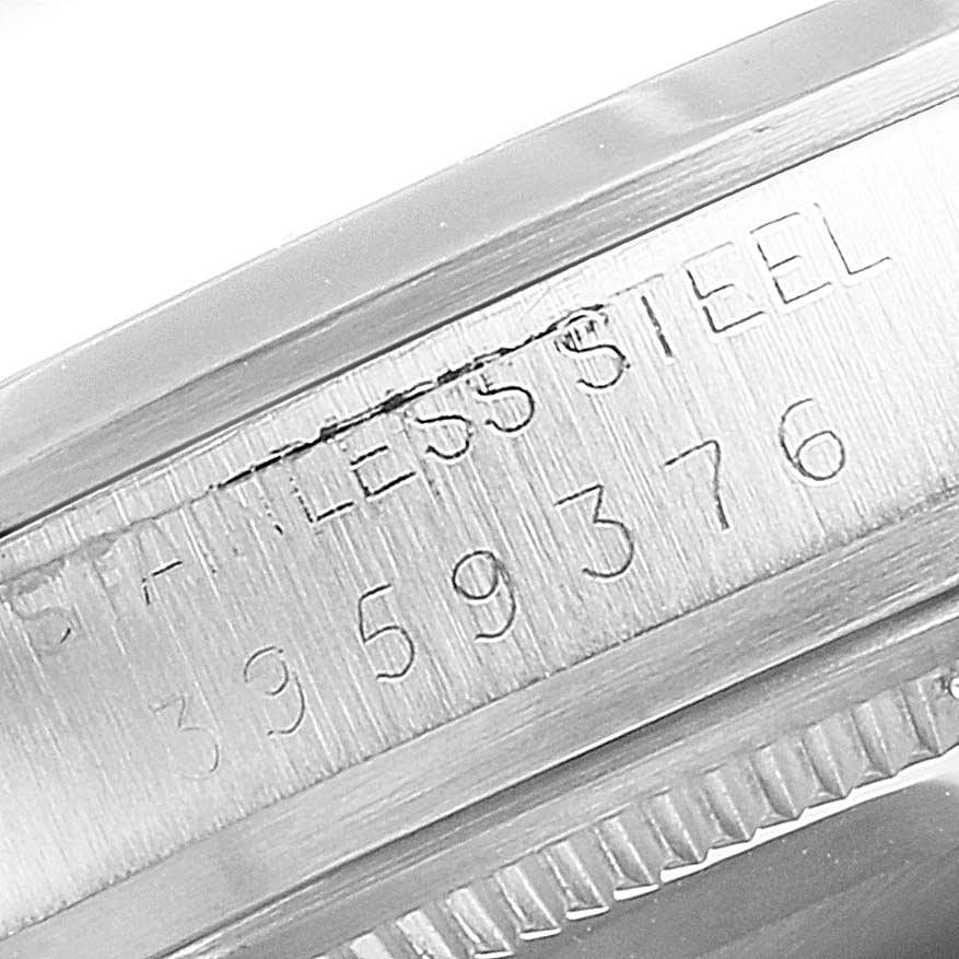 The close-up image shows the case side and serial number imprint of a Vintage Collection Rolex watch.