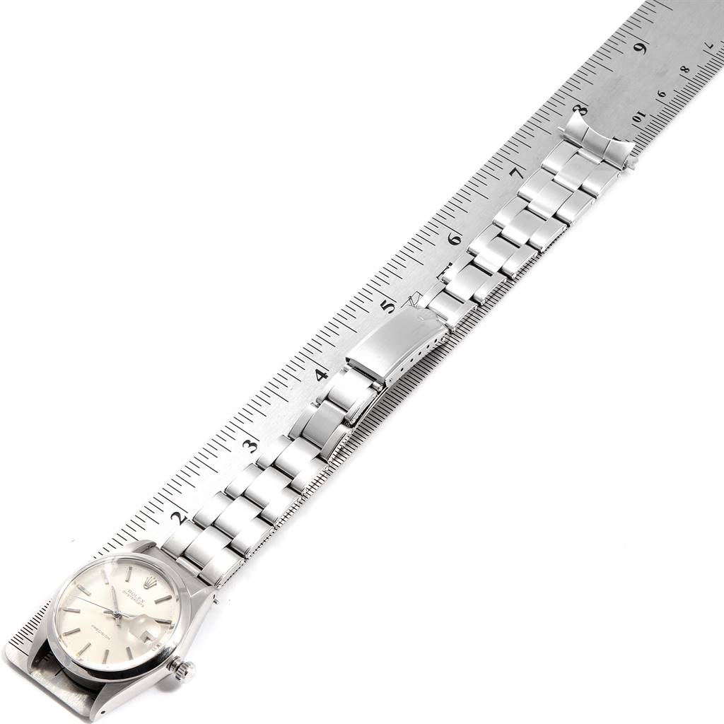 The Vintage Collection Rolex watch is shown flat with its dial, bracelet, and clasp visible alongside a ruler.