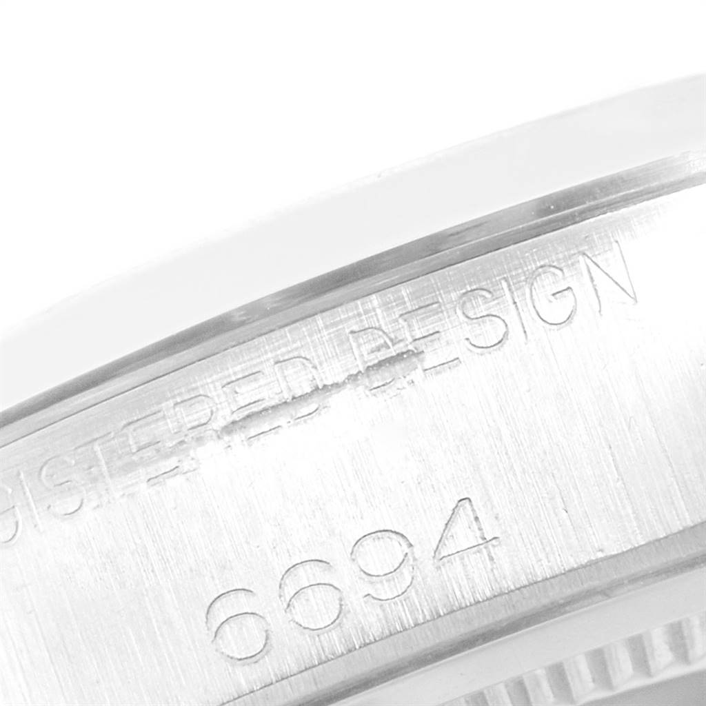 This close-up image shows the engraved case back and text of a Rolex Vintage Collection 6694 Men
s Stainless Steel Silver Dial 6694 Men
s Stainless Steel Silver Dial model 6694.