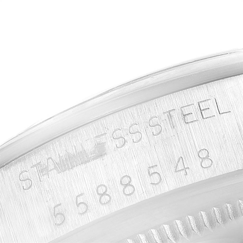 The image shows the stainless steel casing with engraved serial number on a Vintage Collection model by Rolex, viewed from a close-up angle.