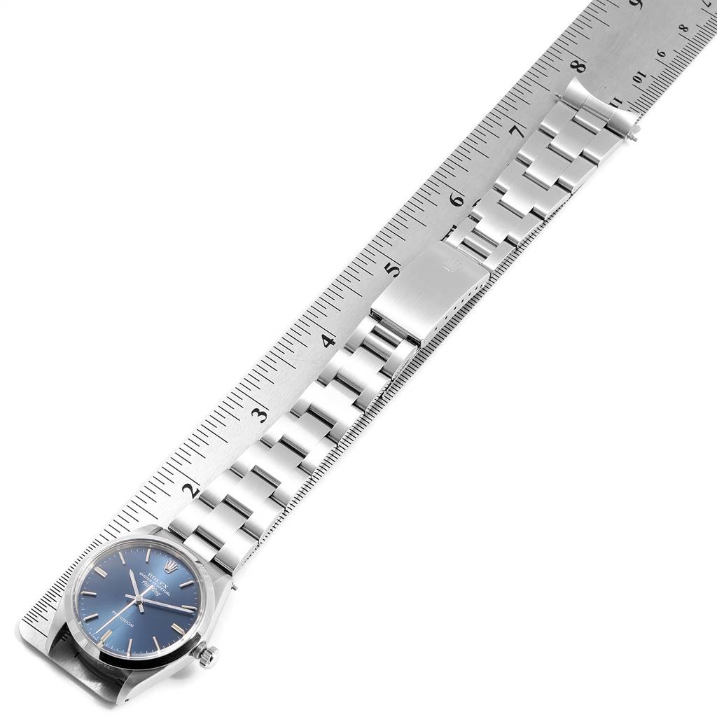 The Rolex Vintage Collection 5500 Men's Stainless Steel Blue Dial 5500 Men's Stainless Steel Blue Dial watch is shown from an overhead angle, displaying the watch face, bezel, and metal bracelet alongside a ruler.