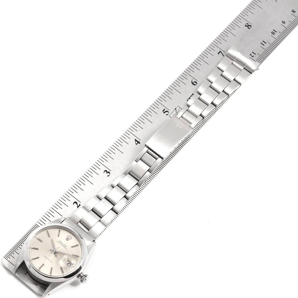 The image features a Vintage Collection Rolex watch, displaying the face, crown, and metal bracelet next to a ruler for scale.