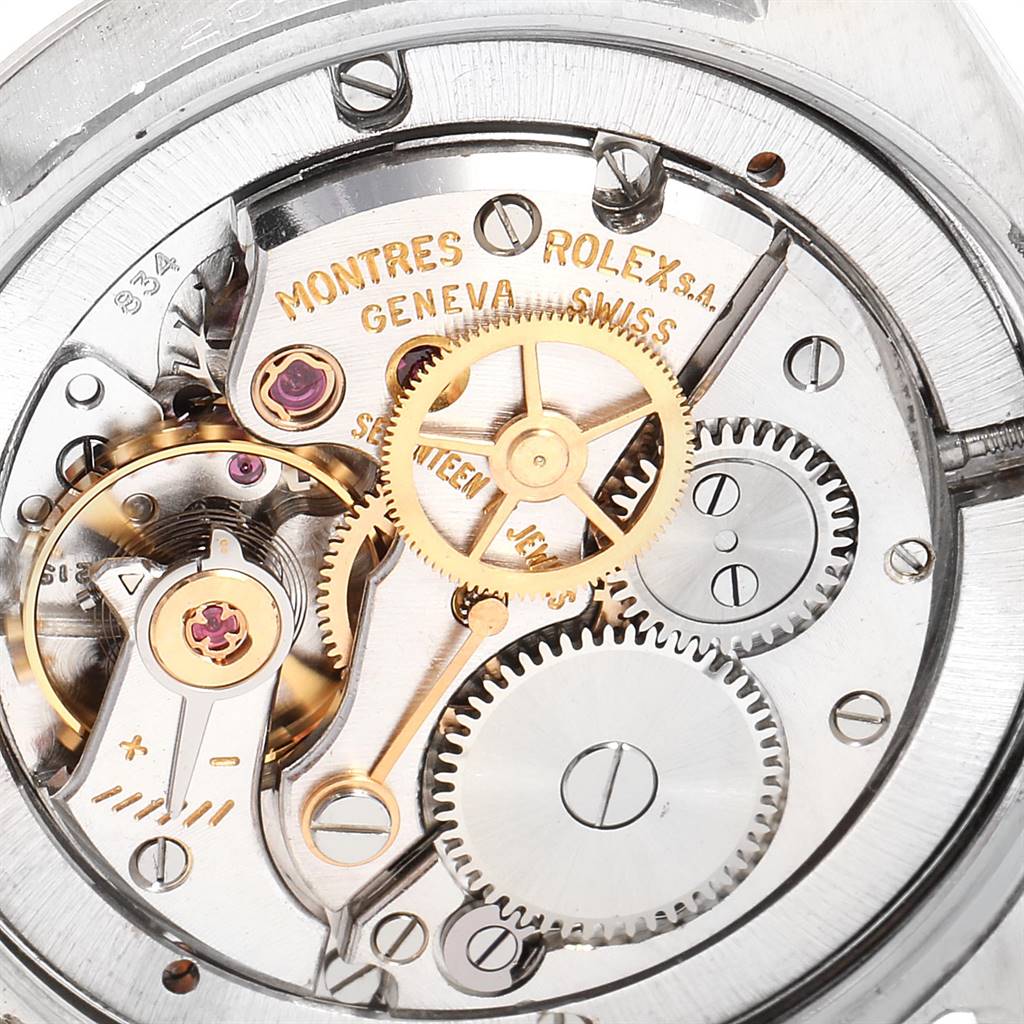 The image shows the intricate internal mechanism of a Vintage Collection model by Rolex, highlighting gears and jewels.