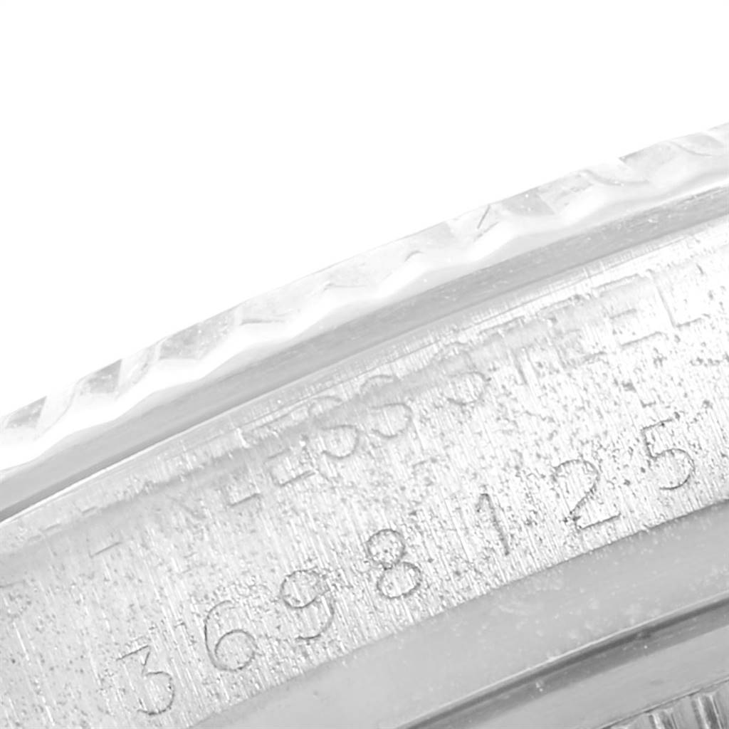 The image shows a close-up of the engraved serial number on the outer rim of the Vintage Collection model by Rolex.