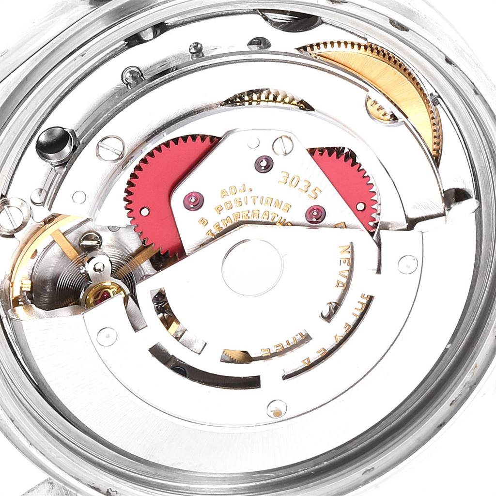The image shows a close-up view of the internal mechanism of a Vintage Collection Rolex watch.