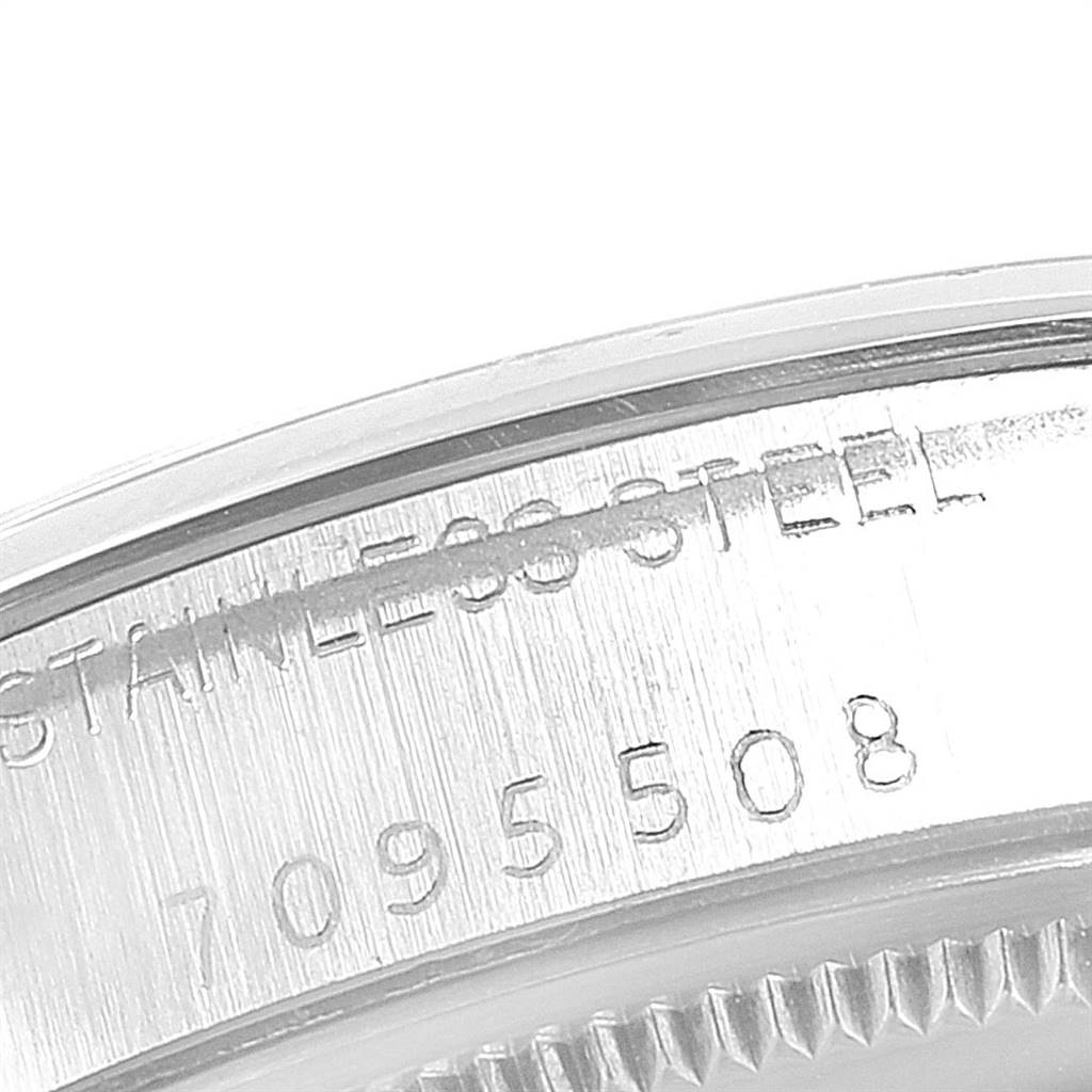 The image shows a close-up of the stainless steel casing of a Vintage Collection model by Rolex, highlighting its serial number.
