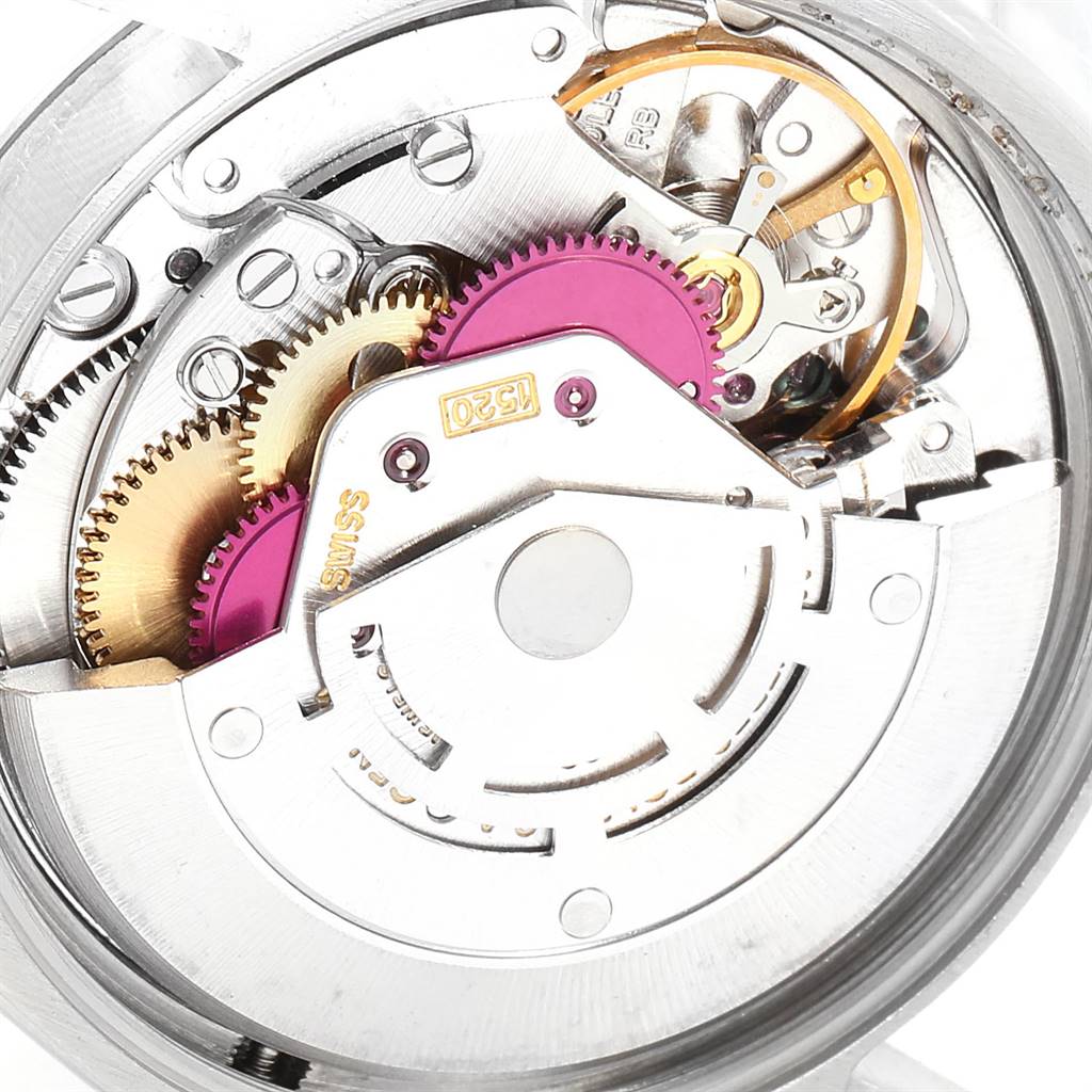 This image shows an internal view of the Vintage Collection model by Rolex, featuring gears and the movement mechanism.