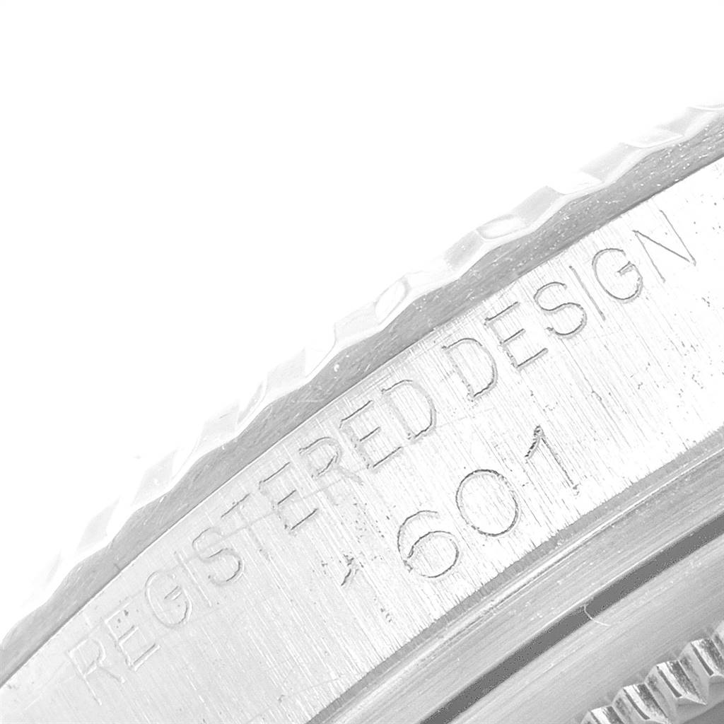 This image shows a close-up of the engraved bezel of a Vintage Collection model by Rolex, highlighting the "REGISTERED DESIGN" inscription and model number.