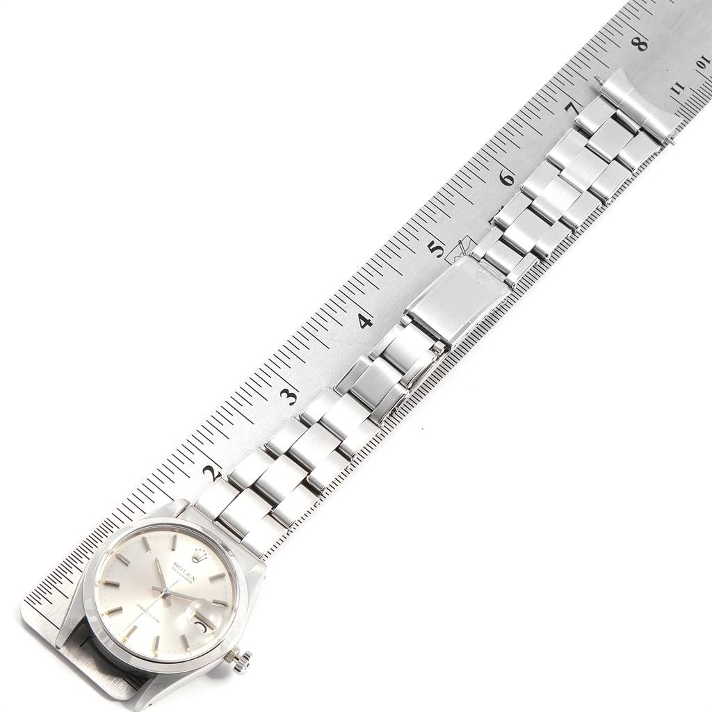 The image shows a top view of a Rolex Vintage Collection 6694 Men
s Stainless Steel Silver Dial 6694 Men
s Stainless Steel Silver Dial watch laid flat with a metal ruler measuring the length of its band.