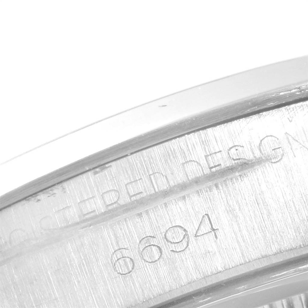 The image shows a close-up of the caseback of a Rolex Vintage Collection 6694 Men
s Stainless Steel Silver Dial 6694 Men
s Stainless Steel Silver Dial model 6694.