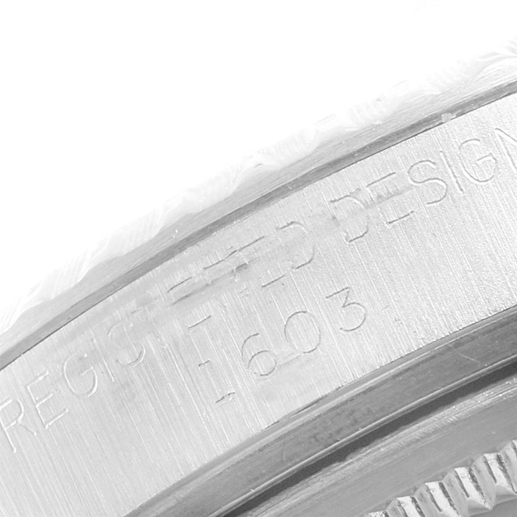 The image shows a close-up of the bezel
s side of a Rolex Vintage Collection 1603 Men
s Stainless Steel Silver Dial 1603 Men
s Stainless Steel Silver Dial model watch, highlighting engraved details.