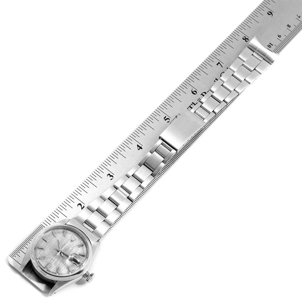 The Rolex Vintage Collection 6694 Men's Stainless Steel Grey Dial 6694 Men's Stainless Steel Grey Dial model watch shows its face, bracelet, and clasp beside a ruler for size reference.