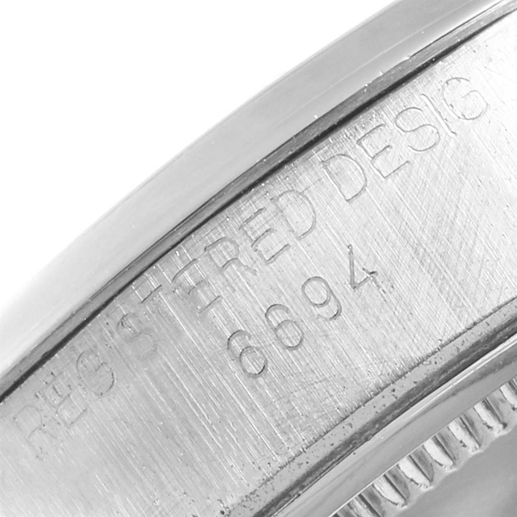 This image shows a close-up of the side casing with the engraved text of a Vintage Collection Rolex watch.