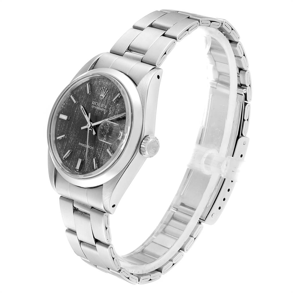 The Vintage Collection Rolex watch is shown from an oblique angle, displaying the face, case, and bracelet.