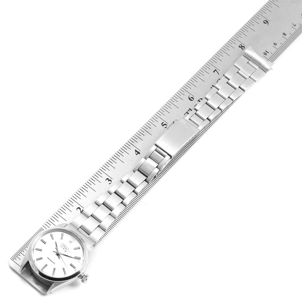 The image shows a top view of a Rolex Vintage Collection 5500 Men
s Stainless Steel Silver Dial 5500 Men
s Stainless Steel Silver Dial watch with its band measured against a ruler.