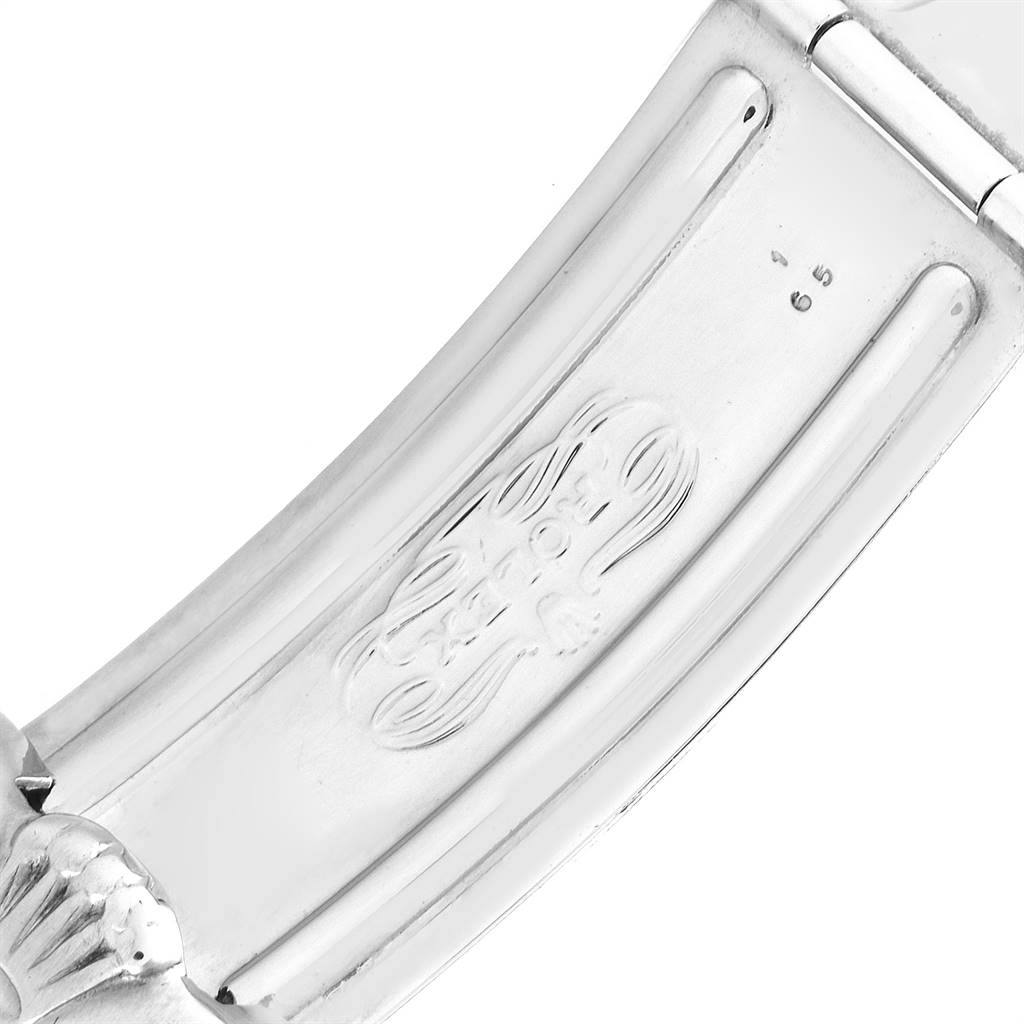 The image displays a close-up of a clasp on a Rolex Vintage Collection 1675 Men
s Stainless Steel Black Dial 1675 Men
s Stainless Steel Black Dial watch, showcasing the brand
s logo and part number.