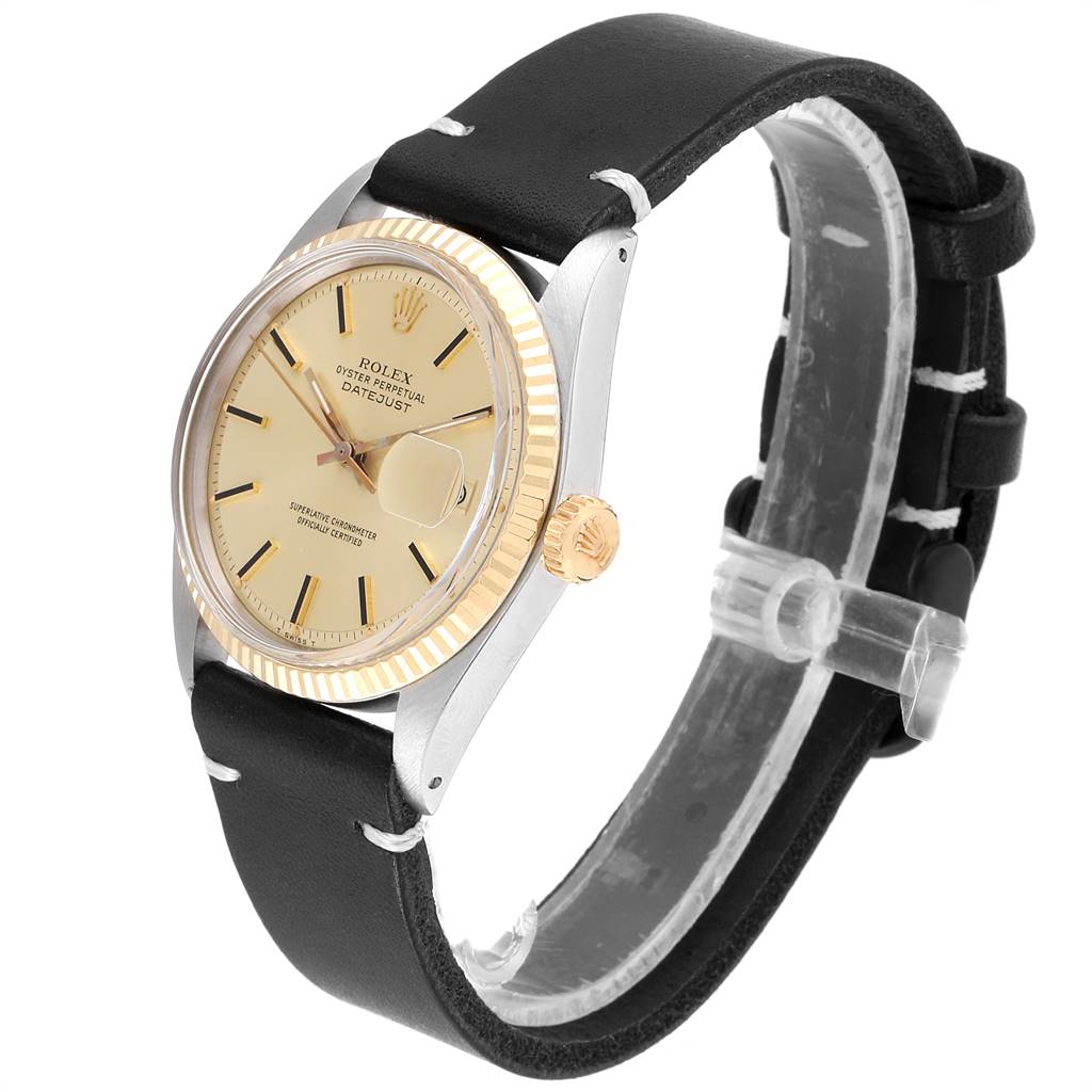 The image shows a side angle of a Rolex Vintage Collection 1601 Men
s Steel and Gold (two tone) Champagne Dial 1601 Men
s Steel and Gold (two tone) Champagne Dial Datejust watch, displaying the face, bezel, crown, and leather strap.