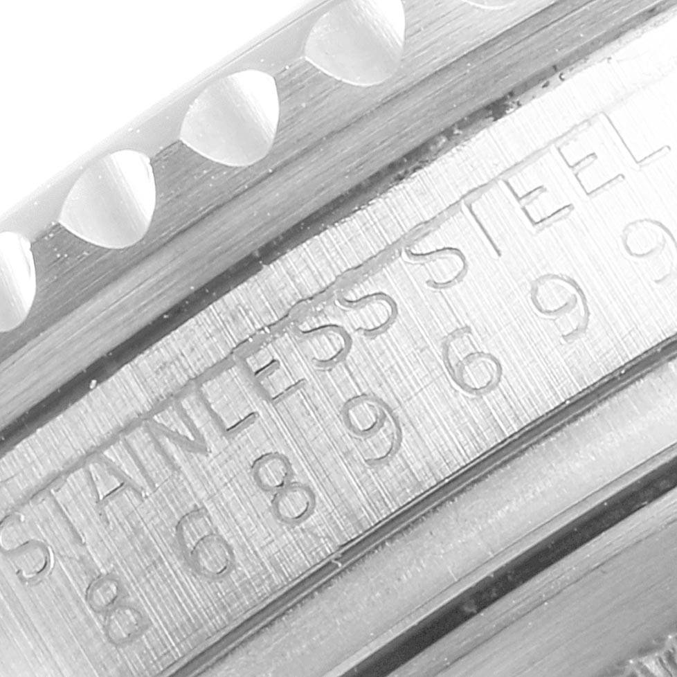 This close-up image shows the engraved stainless steel casing and part of the bezel of the Rolex Vintage Collection 16760 Men
s Stainless Steel Black Dial 16760 Men
s Stainless Steel Black Dial watch.