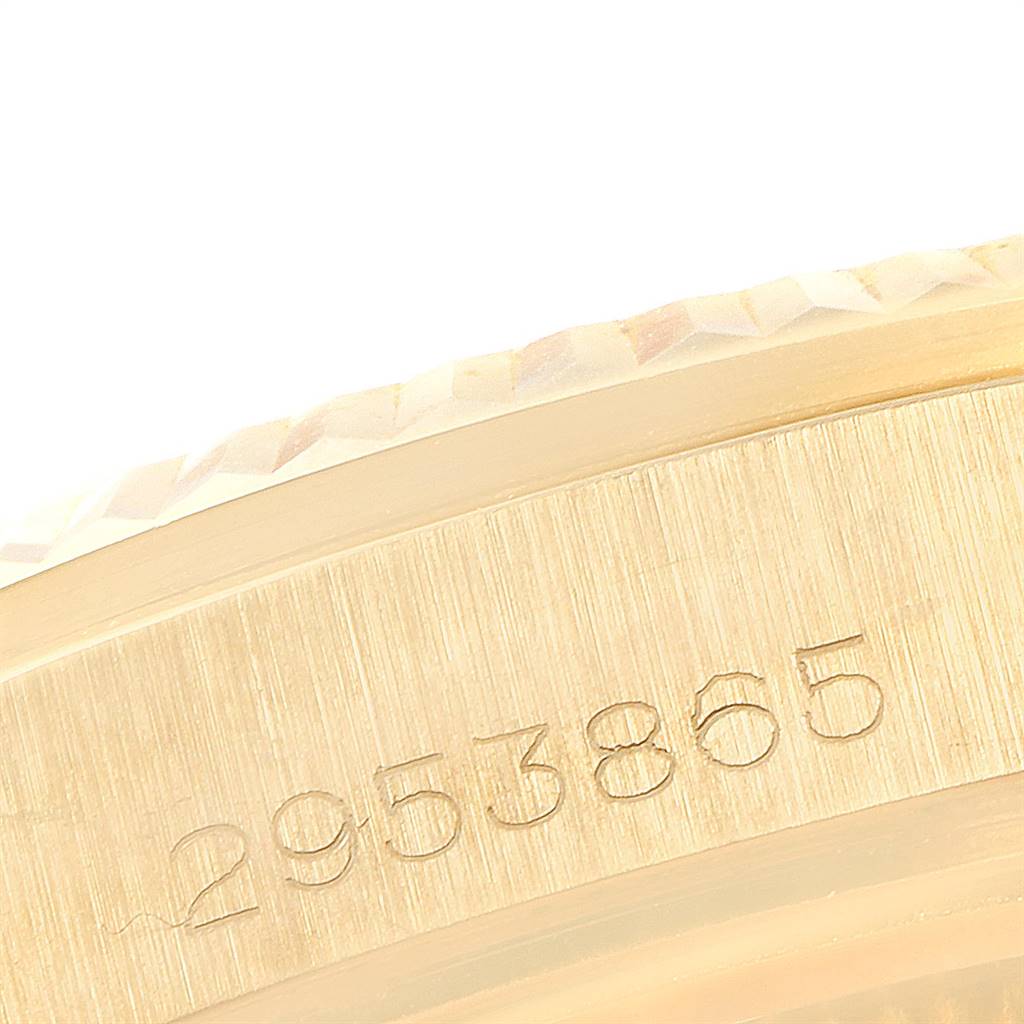 This close-up image of a Rolex Vintage Collection 1803 Men
s Yellow Gold Champagne Dial 1803 Men
s Yellow Gold Champagne Dial watch focuses on the engraved serial number on the gold case.